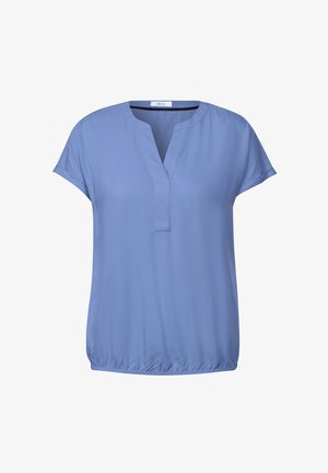 Blouse à manches courtes, bleu clair avec un décolleté en V. Matière douce avec un ourlet légèrement froncé. Design simple et polyvalent.