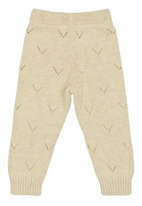 Pantalons en maille beige avec un motif texturé de petites formes en V. Taille élastique et poignets côtelés pour un ajustement confortable.