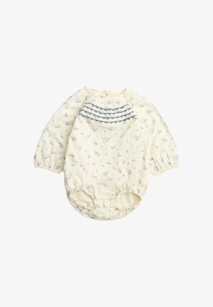 Tutina per neonati a maniche lunghe color crema con piccola stampa floreale e dettagli in pizzo blu a volant sul petto e orli delle gambe elasticizzati.