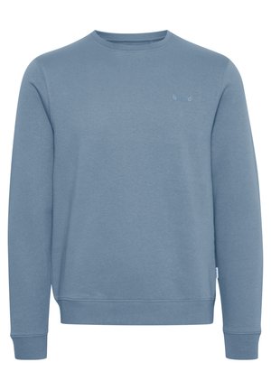 Modrá mikina vyrobená z měkké, texturované látky. Design s kulatým výstřihem, dlouhými rukávy a žebrovanými cuffy. Jemný detail loga na přední straně.