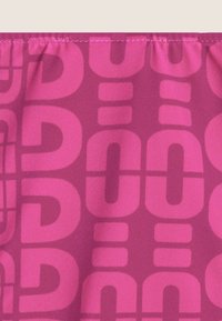 Kangas decorated with large, bold, intertwining letters in shades of pink on a darker pink background, featuring a smooth texture.