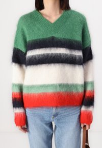 Multicolored knitted sweater featuring green, navy, white, and red stripes. V-neck design with a soft, fluffy texture and long sleeves.