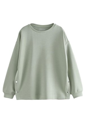 Jasnozielona bluza oversize z długimi rękawami, okrągłym dekoltem, prążkowanymi mankietami i bocznymi zatrzaskami na dole.