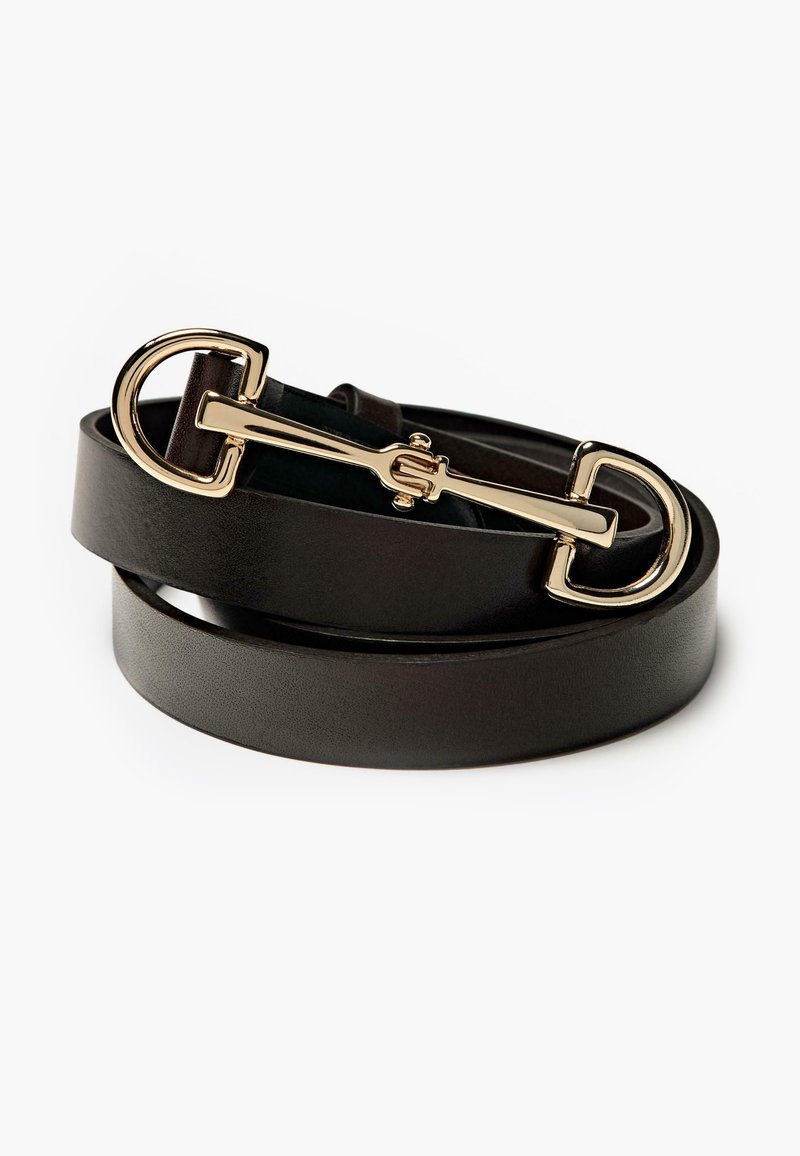 Ceinture en cuir noir avec une boucle en or brillante arborant un design semi-circulaire et une sangle étroite. Texture lisse, style minimaliste.