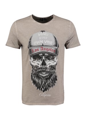 Beige Baumwoll-T-Shirt mit einem schwarzen Schädeldruck, der einen Bart und eine Mütze trägt. Der Text beinhaltet "Mind your own vibe" und "Los Angeles."
