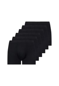 Slip neri esposti in fila, caratterizzati da un tessuto morbido, una cintura elastica e un design aderente con una tasca sagomata.