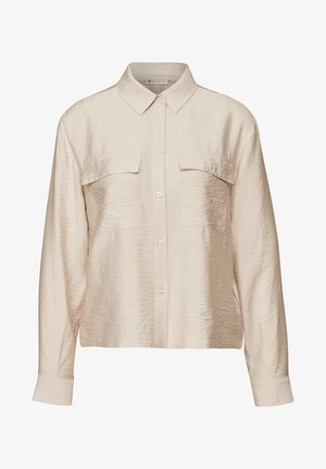 Beżowa koszula z długim rękawem, wykonana z gładkiego, lekkiego materiału. Posiada zapięcie na guziki z przodu, kołnierz oraz dwie kieszenie na piersi. Miękka tekstura.