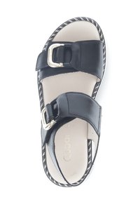 Black leather sandals with two adjustable straps, featuring a silver-tone buckle, a cushioned insole, and a textured, striped sole.