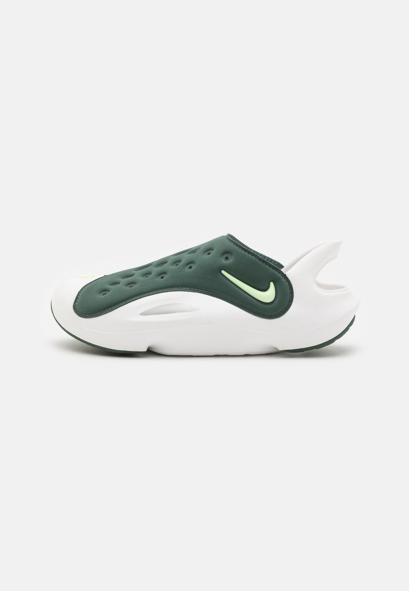 Green and white sporty shoe with a smooth, molded design, featuring ventilation holes, a cushioned sole, and a signature logo accent.