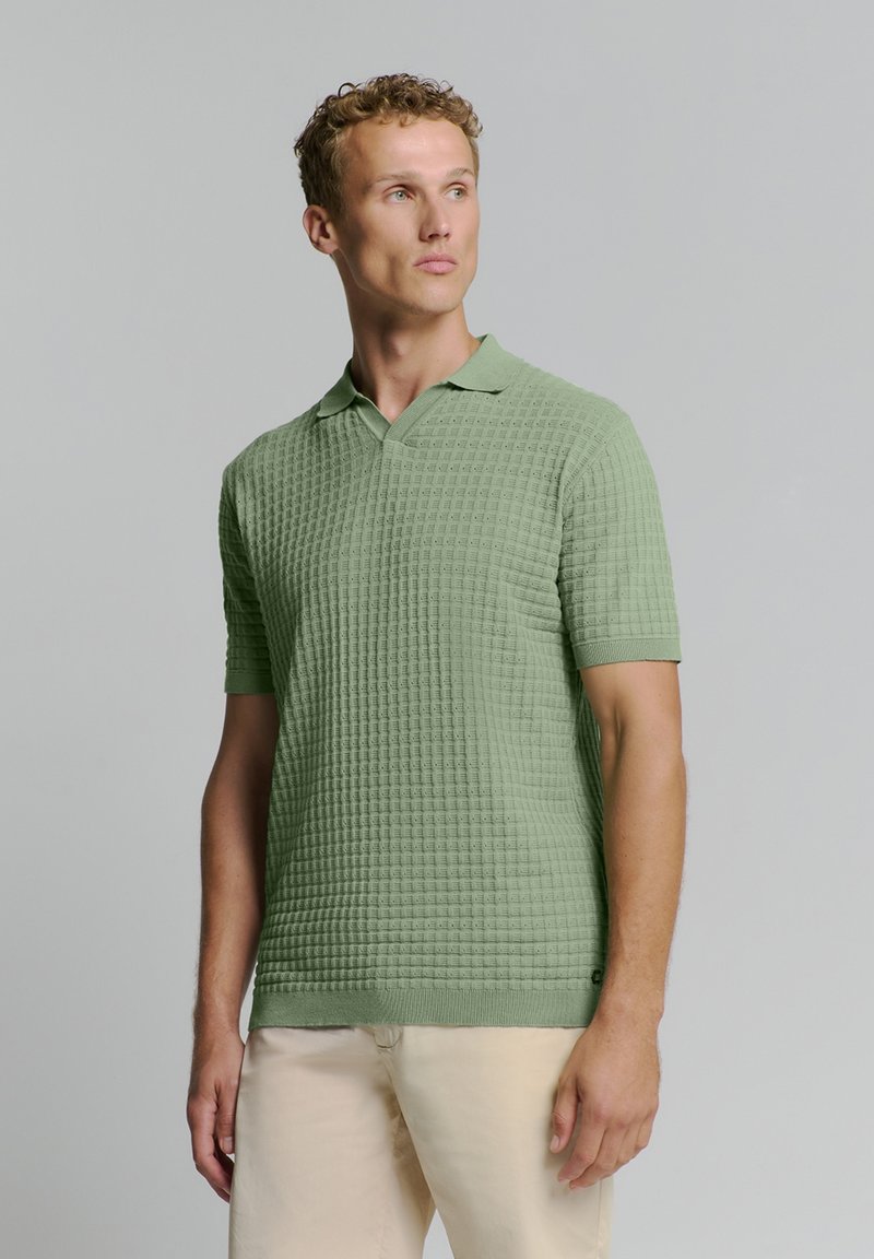 Korte mouwen polo shirt in lichtgroen met een gestructureerd wafelpatroon, een notch-kraag en een ribbelzoom. Geschikt voor casual kleding.