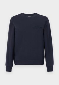 Bluză bleumarin cu mâneci lungi, cu manșete și tiv răsucite, având un logo brodat discret pe partea stângă a pieptului.