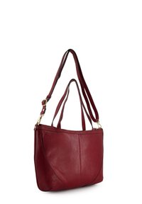 Red leather shoulder bag with dual straps, smooth texture, zip closure, and accent stitching. Features a rounded bottom and sleek design.