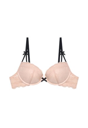 Sujeción beige acolchada de encaje con tirantes negros ajustables y pequeños lazos negros en los tirantes y en el centro delantero.