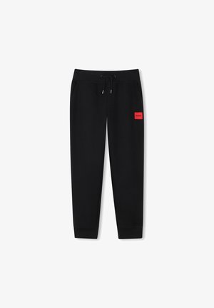 Black sweatpants made of soft fabric, featuring an adjustable drawstring, tapered legs, and a red logo patch on the left thigh.