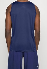 Navy blue sleeveless athletic tank top with a mesh texture, round neck, and subtle branding near the hem. Back view shows smooth fabric.