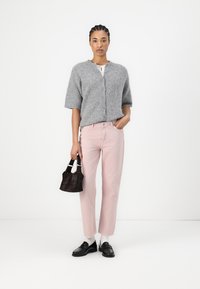 Gray short-sleeve cardigan, light pink straight-leg jeans, black loafers, and a small black handbag. Simple, textured designs throughout.
