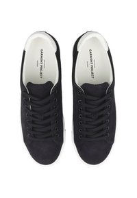 Pair of black suede lace-up sneakers with white soles, viewed from above, branded "Garment Project" inside.