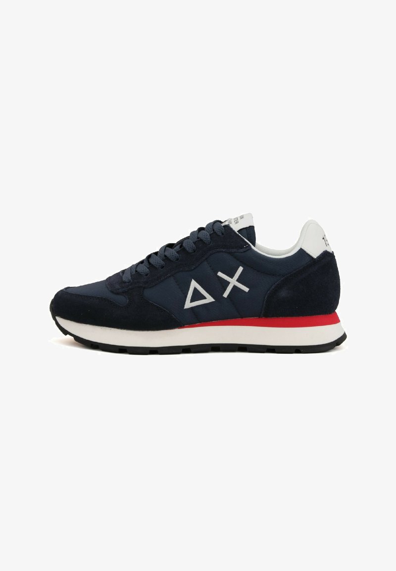Sneaker blu navy con tomaia in suede e tessuto, dettagli bianchi e rossi, suola di gomma piatta e logo geometrico sul lato.