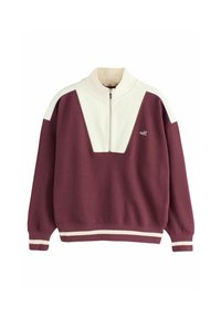 Felpa con zip nei colori bordeaux e crema, caratterizzata da un distintivo design triangolare e un orlo a coste, contrassegnata con il nome del marchio "self."