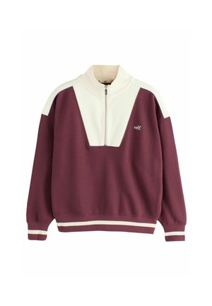 Bordeaux en crèmekleurige rits sweatshirt met een kenmerkend driehoekig ontwerp en een geribde zoom, gelabeld met de merknaam "self."
