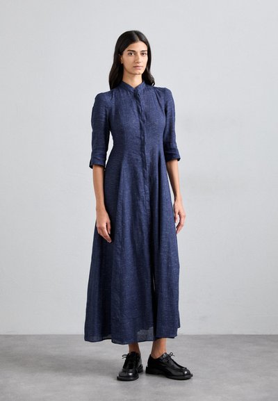 Navy blue linen dress with a button front, collared neck, and three-quarter sleeves; features a flowing silhouette and textured fabric.