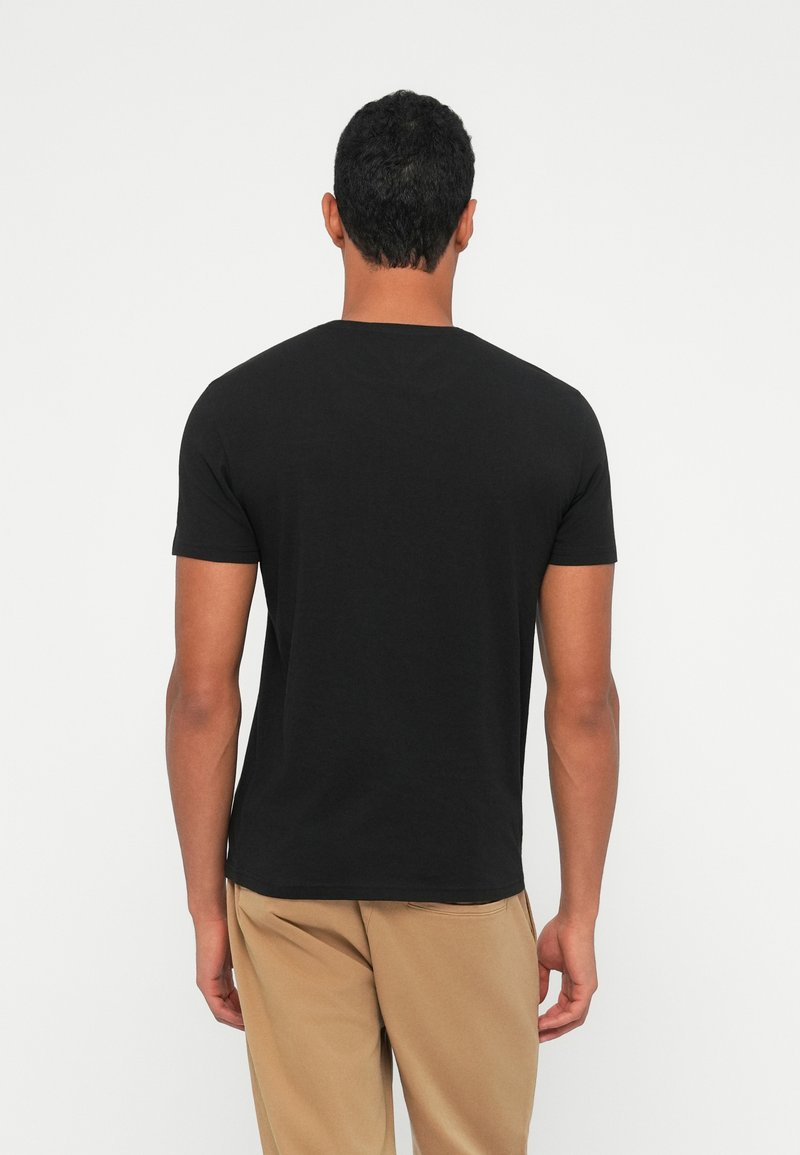 Black short-sleeve t-shirt made of cotton, featuring a crew neck and a standard fit. Back view shows smooth fabric texture with no patterns.