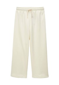 Shorts de sport crème, de longueur genou, en tissu doux, avec une taille élastique dotée d'un cordon de serrage ajustable et un ourlet cousu.