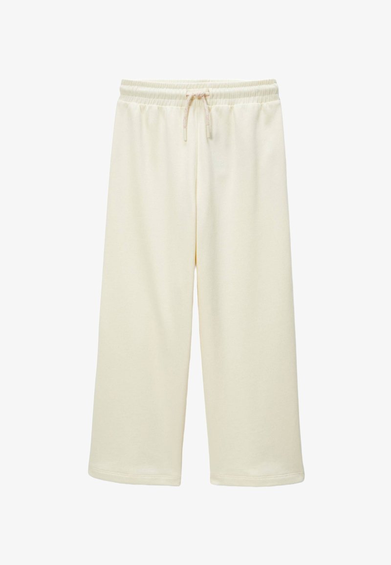 Shorts de sport crème, de longueur genou, en tissu doux, avec une taille élastique dotée d'un cordon de serrage ajustable et un ourlet cousu.