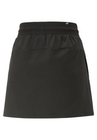 Gonna sportiva nera realizzata in tessuto morbido, con vita elasticizzata, forma svasata e tasche laterali per la praticità.