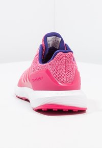 Růžová a fialová běžecká bota s pletenou texturou, bílou podrážkou a značkováním "rapidRUN" na patě, zobrazená zezadu na bílém pozadí.