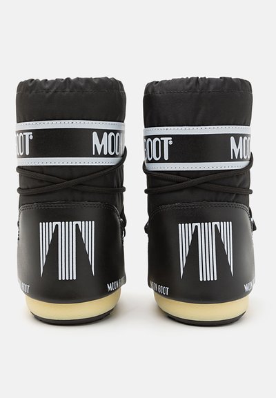 Black insulated snow boots with a rounded shape, featuring a white logo band, a textured surface, and vertical striped accents.