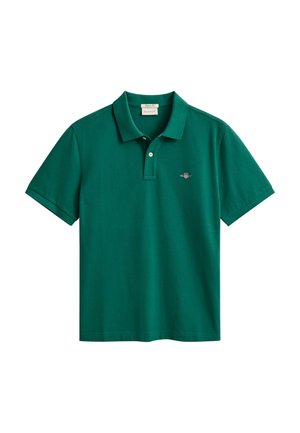 Grøn bomulds polo med korte ærmer og klassisk krave. Har en lille logo på venstre bryst. Glat tekstur, afslappet design.