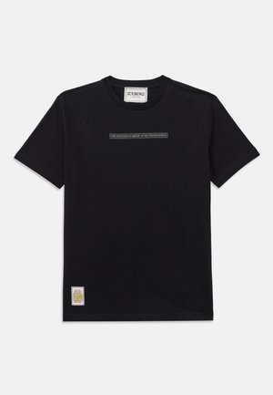 Sort bomulds T-shirt med korte ærmer. Har et rektangulært tekstgrafik i midten og en farverig label nederst til venstre.