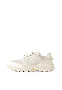Beige sneakers with mesh and suede materials, featuring a padded collar, lacing system, and textured rubber sole with a distinctive logo.