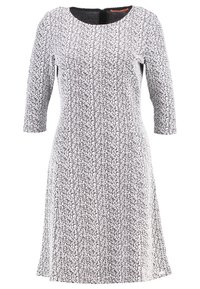 Svart- och vitmönstrad klänning, knälång, rund halsringning och trekvartslånga ärmar. Strukturerad tyg med en lätt A-linjeform.