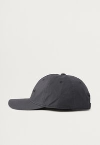 Casquette gris foncé en tissu, avec une visière pré-incurvée, des œillets cousus et un logo sur le panneau avant. Design classique réglable.