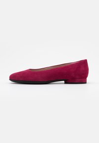 Fuchsia suede ballet flats with a rounded toe and a low, square heel. The sole is black, contrasting the vibrant upper material.