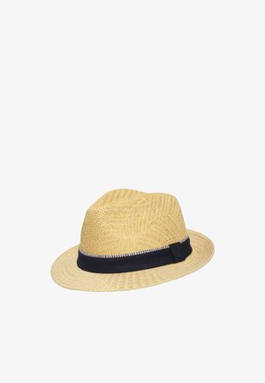Beige woven straw fedora hat with a black fabric band featuring a white zigzag pattern along the edge.