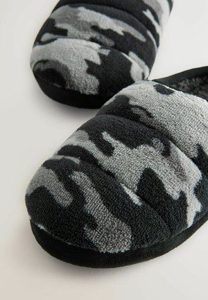 Schwarze und graue Kamuflage-Hausschuhe aus plüschigem Stoff, gepolstertem Design und runder Zehenform, mit einer strukturierten Oberfläche und weicher Innenausstattung.