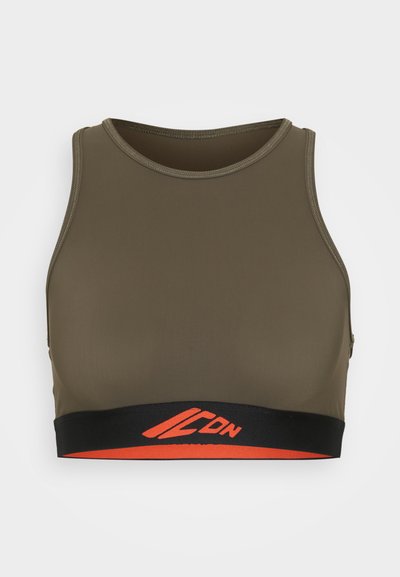 Olive green sports bra with a rounded neckline, elastic black band featuring orange logo detail, and smooth, stretchy fabric.
