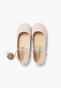 Pale pink ballet flats with a soft fabric upper, rounded toe, and ankle strap. Includes a roll of matching ribbon.