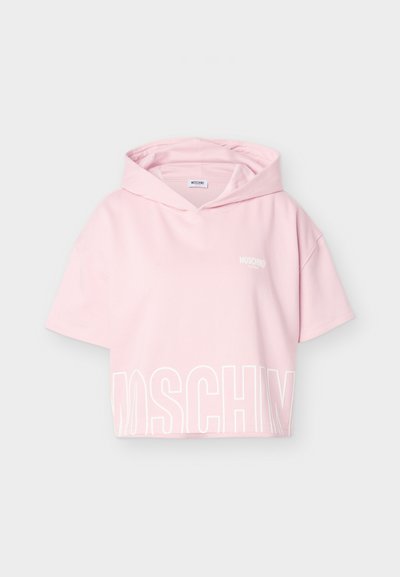 Light pink short-sleeve cropped hoodie with a large white "MOSCHINO" logo at the bottom and a small logo on the chest.