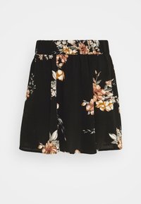 Jupe noire à motif floral avec une taille élastique, présentant des fleurs beiges et blanches ainsi que des feuilles vertes, fabriquée en tissu léger et fluide.