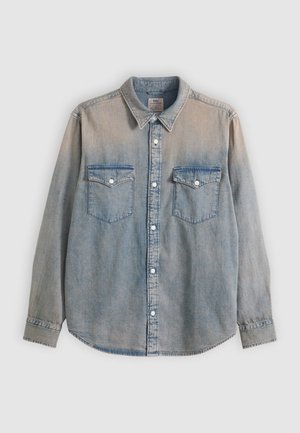 Light blue faded denim long-sleeve shirt with collar, button-front closure, and two button-flap chest pockets.