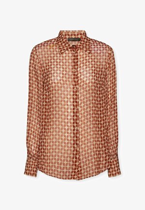 Blusa a maniche lunghe in tessuto leggero color marrone chiaro con motivo a pois in marrone scuro. Collo classico, chiusura con bottoni e maniche con polsini.