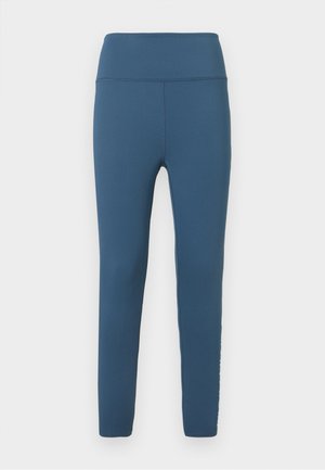 Blaue hochtaillierte Leggings aus dehnfähigem Stoff. Glatte Textur mit schmalem Schnitt und genähten Details entlang der Nähte.