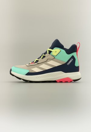 Beež, mündi roheline ja tumesinine matkamisel sneaker kollaste nööpidega, musta tallaga, roosa kannaosaga ja "TERREX" märgisega küljel.