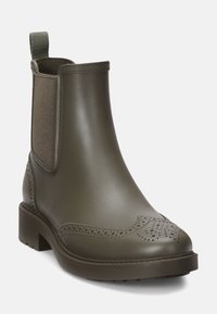 Botas Chelsea verde-oliva com um acabamento suave e brilhante, painéis laterais elásticos, detalhes decorativos de brogue e uma sola resistente.
