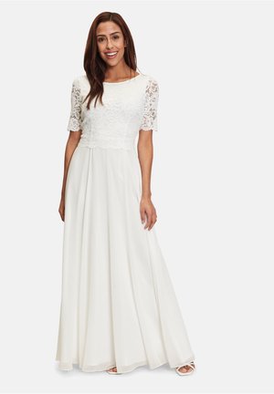 White maxi dress featuring a lace bodice with short sleeves, flowing skirt, and a smooth texture. Includes a fitted waist and layered design.