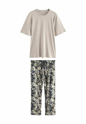 Lys beige kortærmet t-shirt lavet af bomuld, parret med marineblå pyjamasbukser med blomstermønster, der har en elastisk talje og en afslappet pasform.